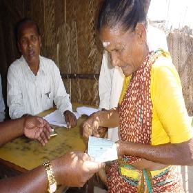 Chennai (Tamil Nadu) A woman receiving a coupon for subsidies and daily commodities